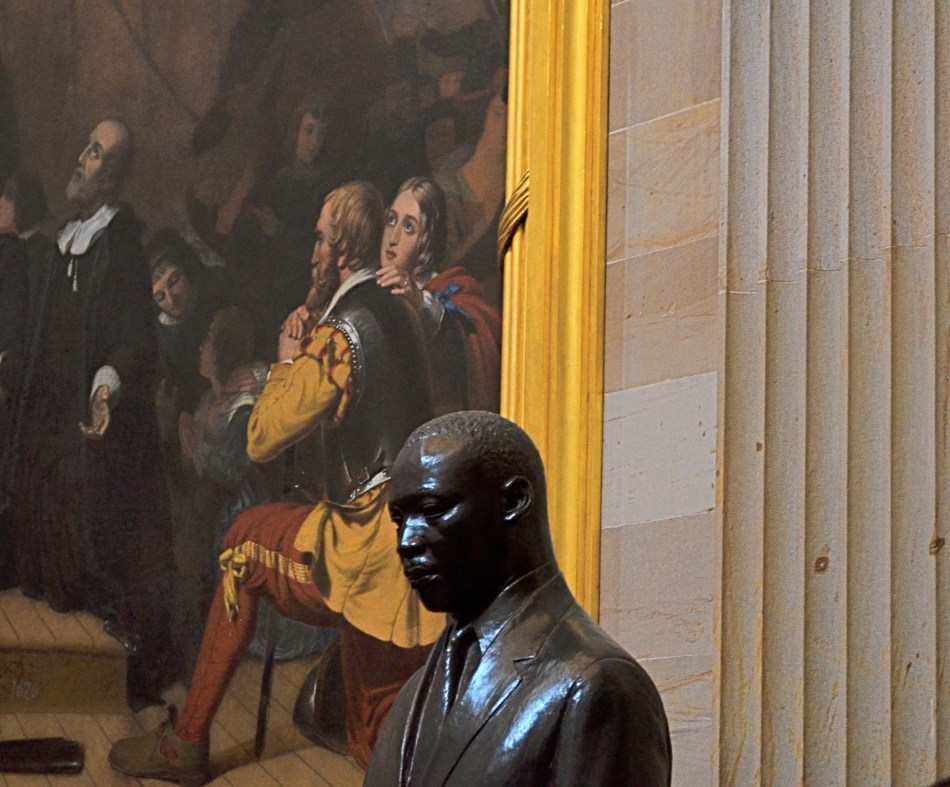 A somber bronze bust of Dr. King in the U.S. Capitol rotunda, flanked by the painting The Embarkation Of The Pilgrims. 1/30 sec., f/5.6, ISO 640, 55mm.