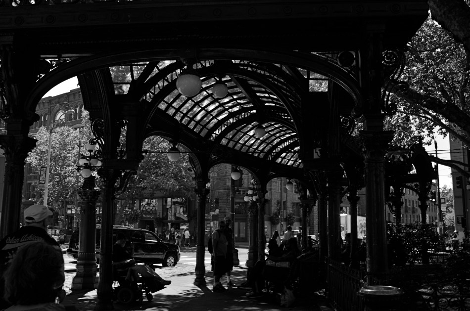 Local characters convene under an aging arch in downtown Seattle.